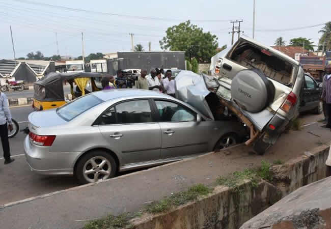 Car driver crushes four passengers waiting for bus, mob burns vehicle