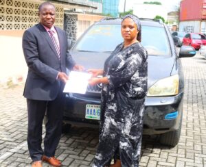 *EFCC officer handing over recovered assets to the Australian victim's lawyer, Blessing Nwankwo, on Wednesday, 15 July 2026.